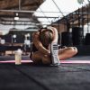 fit-young-woman-doing-stretches-on-a-gym-floor-QVWG8LX-min.jpg